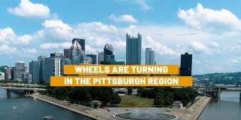 Photo of Pittsburgh Pennsylvania with the words "Wheels are turning in the Pittsburgh region"