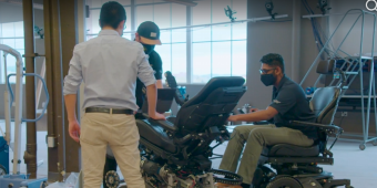 Individuals discussing robotic wheelchair